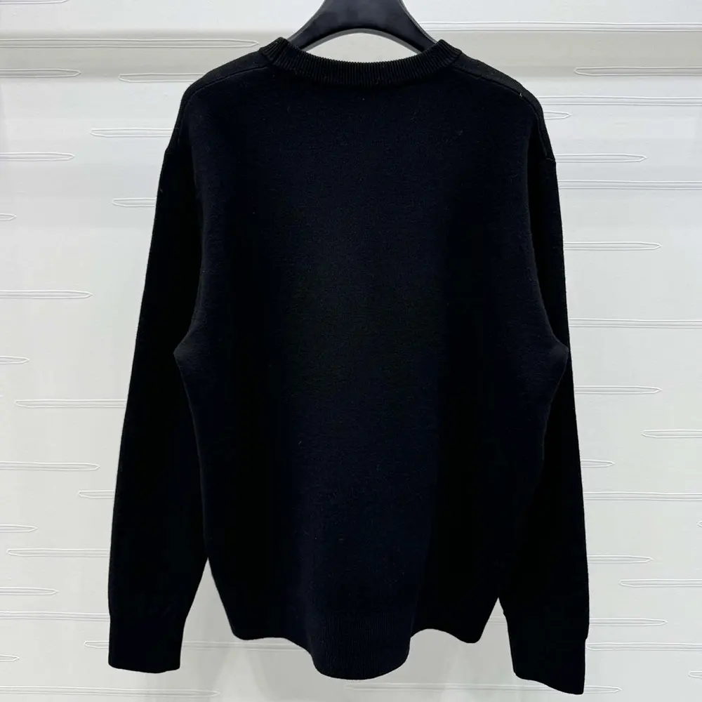 Side angle showing silhouette and texture of Dior Couture sweater