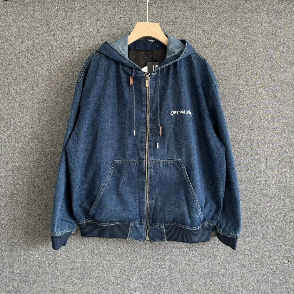 Close-up of signature Christian Dior tag on blue cotton denim jacket