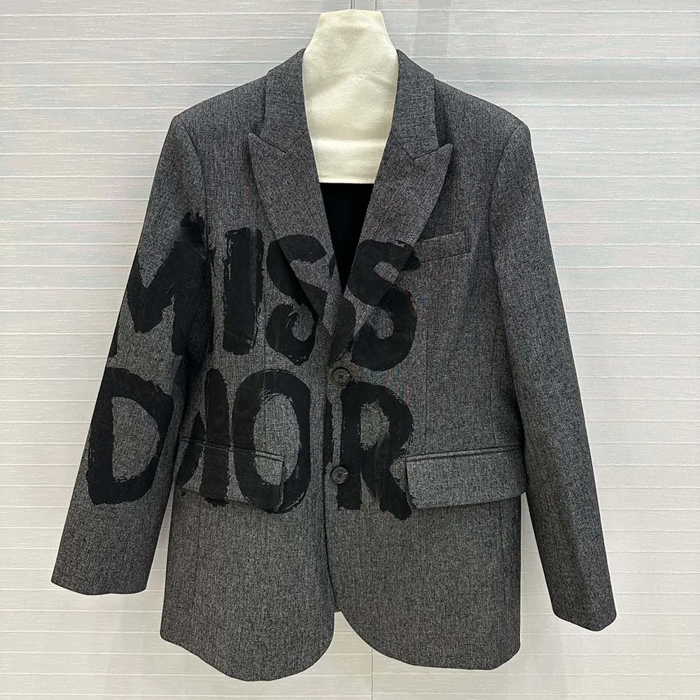 Close-up of black Miss Dior graffiti motif on gray virgin wool blazer