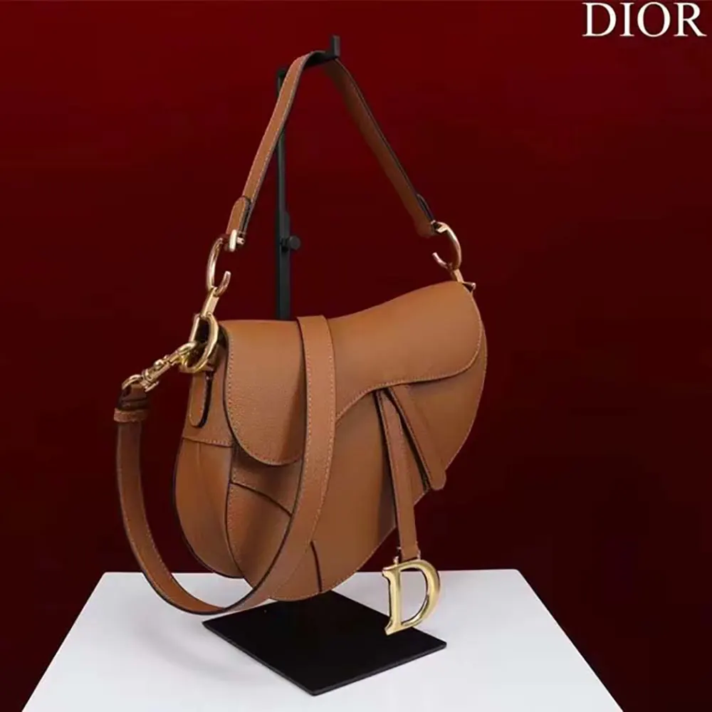 Detail showing texture of brown grained calfskin on Dior Women CD Saddle Bag Strap