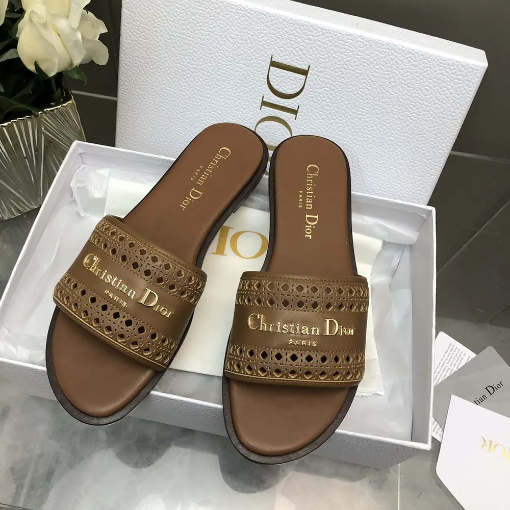 Close-up detail of chocolate leather microcannage openwork on Dior sandal