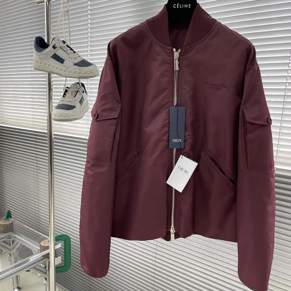 Close-up of signature Dior hardware on Burgundy technical fabric bomber jacket