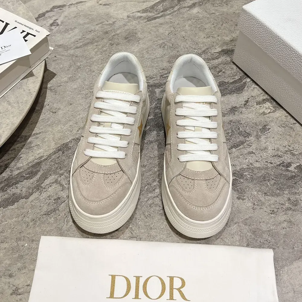 Close-up on signature star hardware on Dior Star Platform Sneaker
