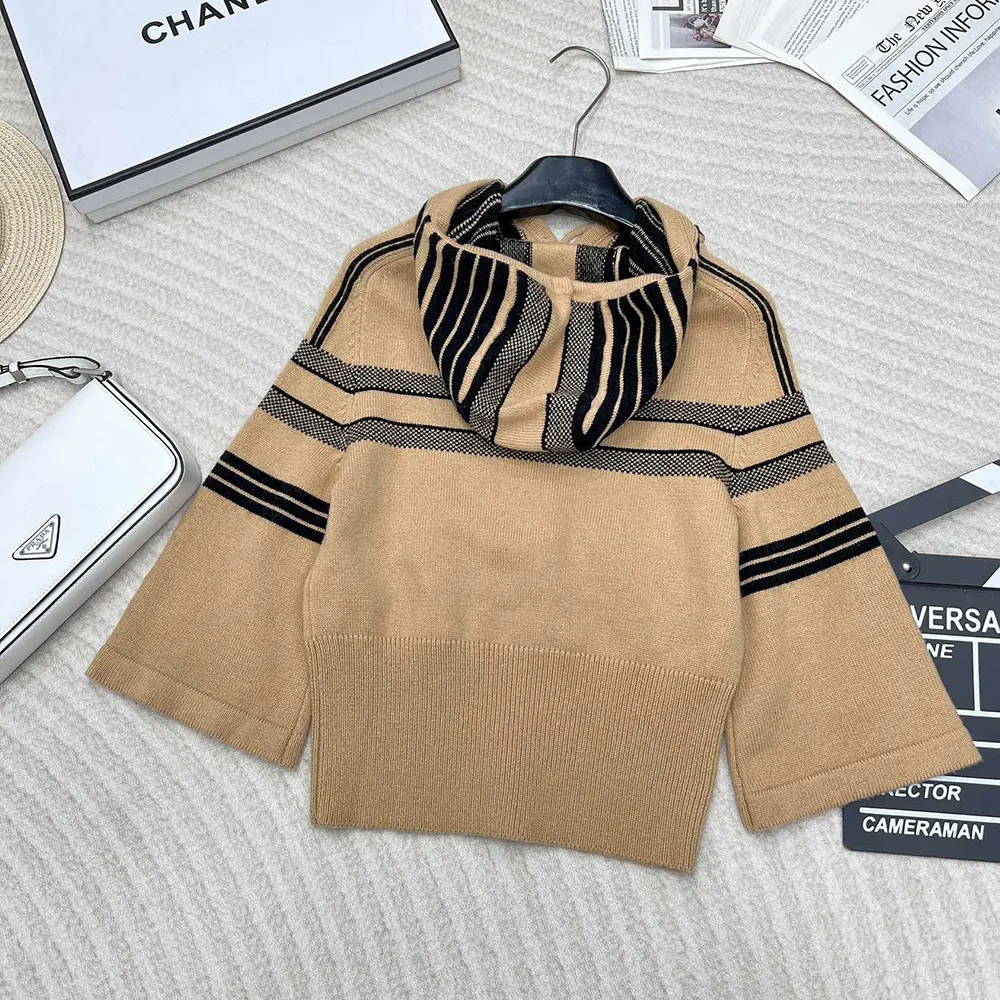 Side angle showing relaxed fit and three-quarter sleeves of Dior sweater