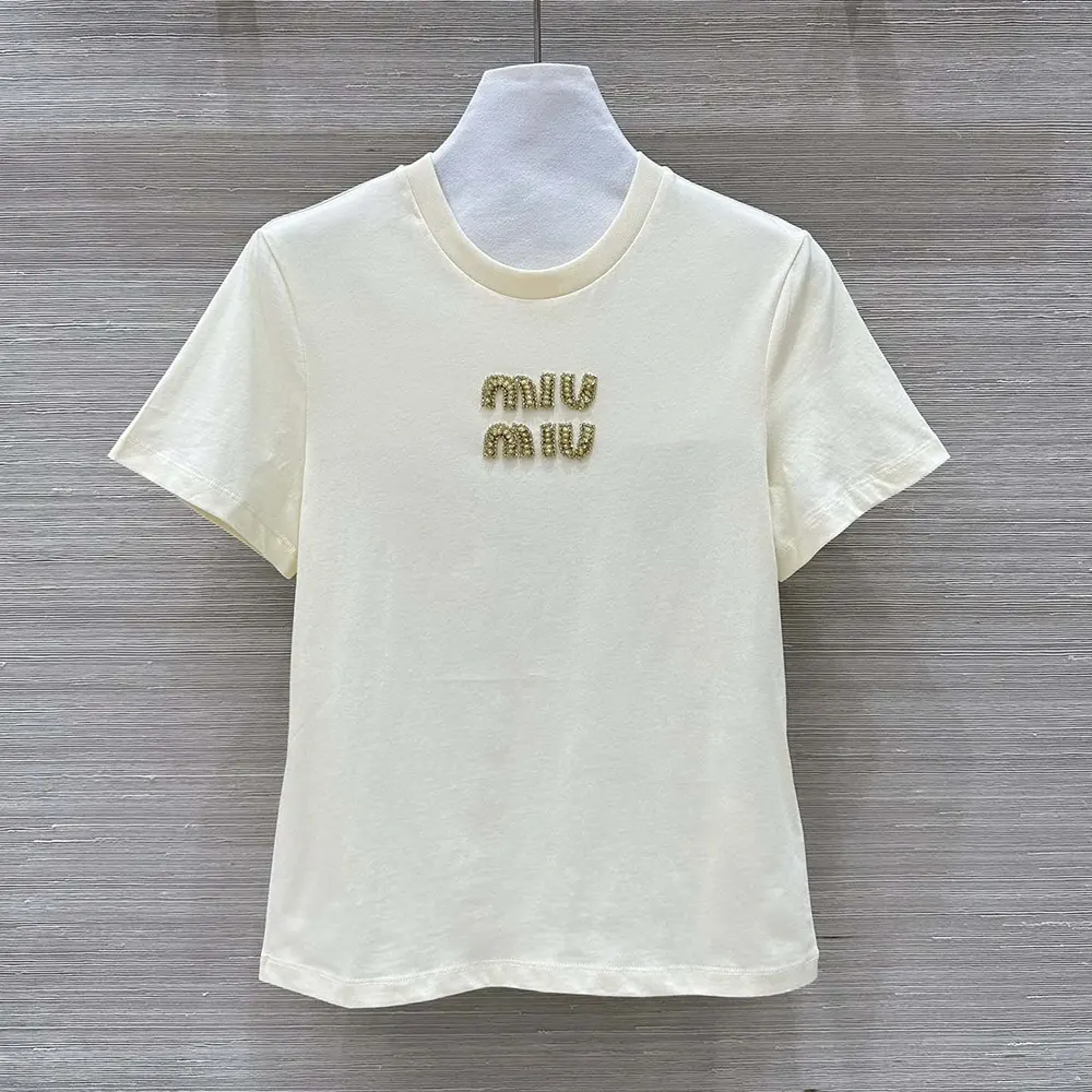 Close-up of embroidered Miu Miu logo on white jersey T-shirt