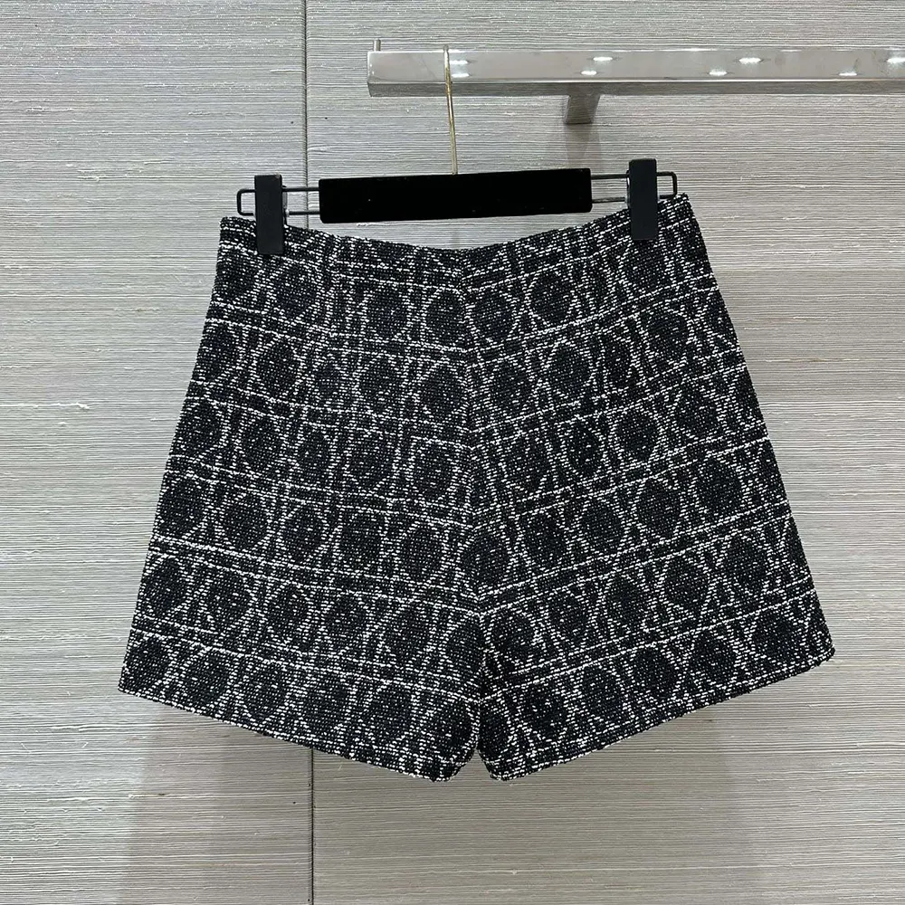 Side angle showing tailored silhouette of Dior Women Macrocannage Shorts black and white