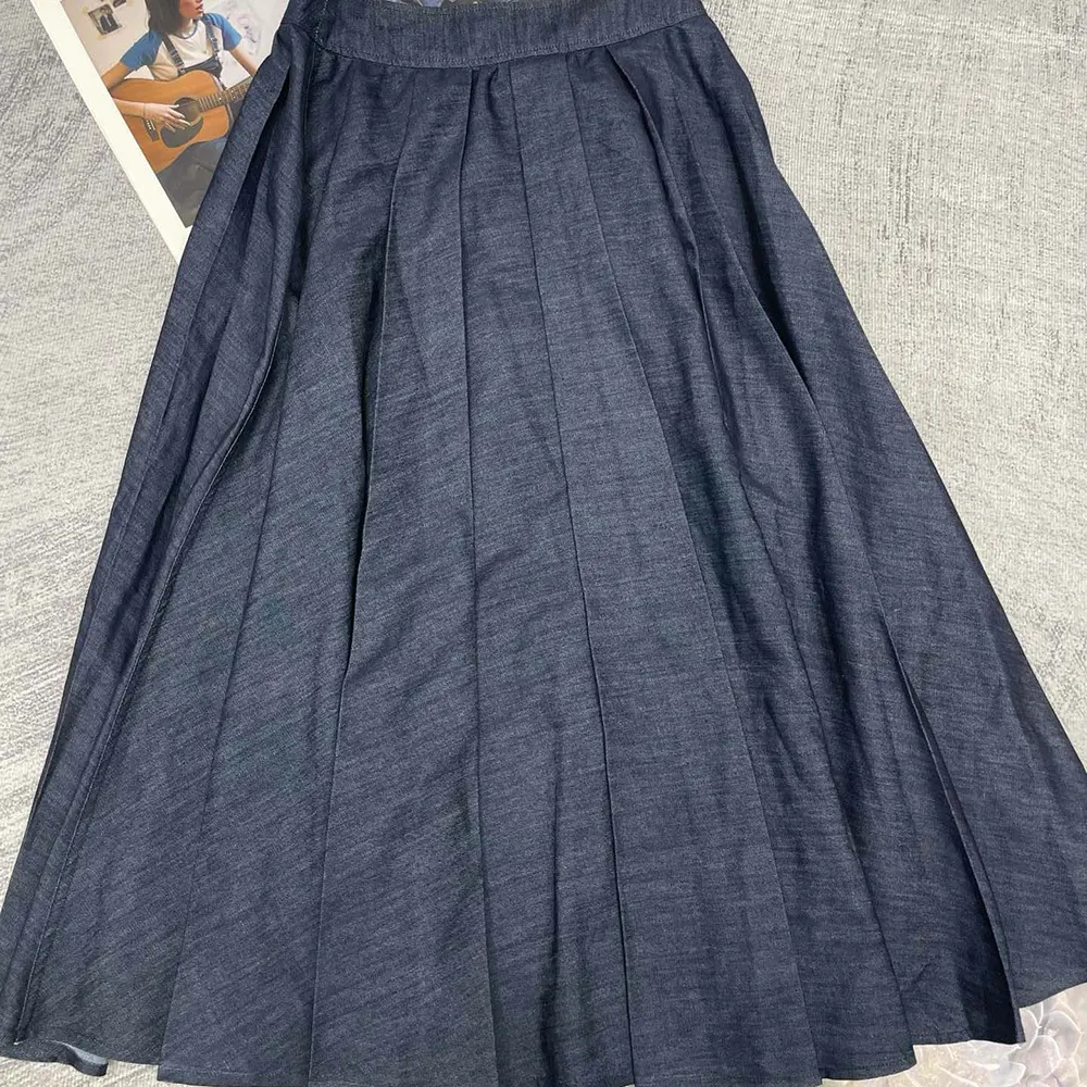 Side angle showing silhouette of Dior Women Mid-Length Deep Blue Denim Skirt