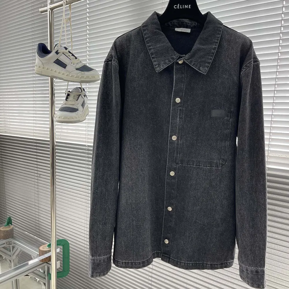 Close-up of Dior engraved buttons on black cotton twill overshirt
