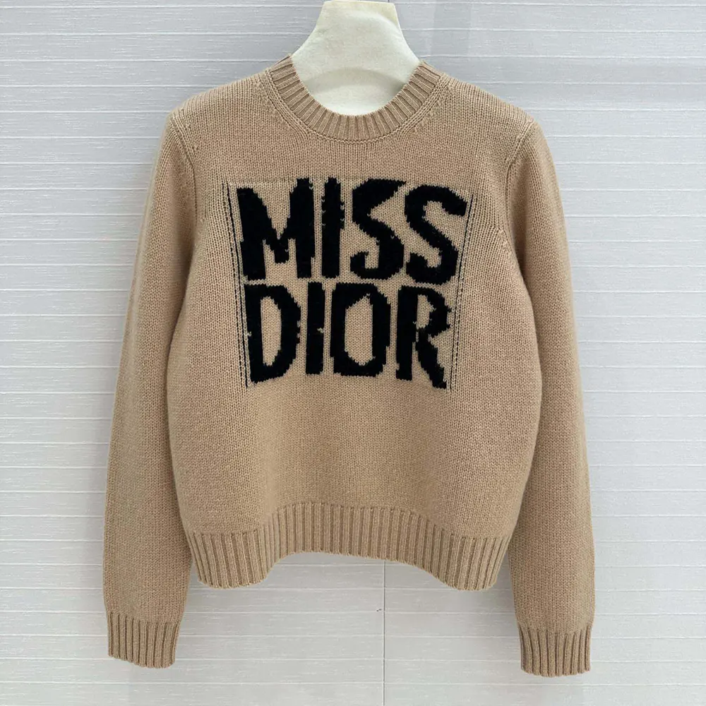 Close-up of black Miss Dior graffiti motif on pale pink cashmere silk knit