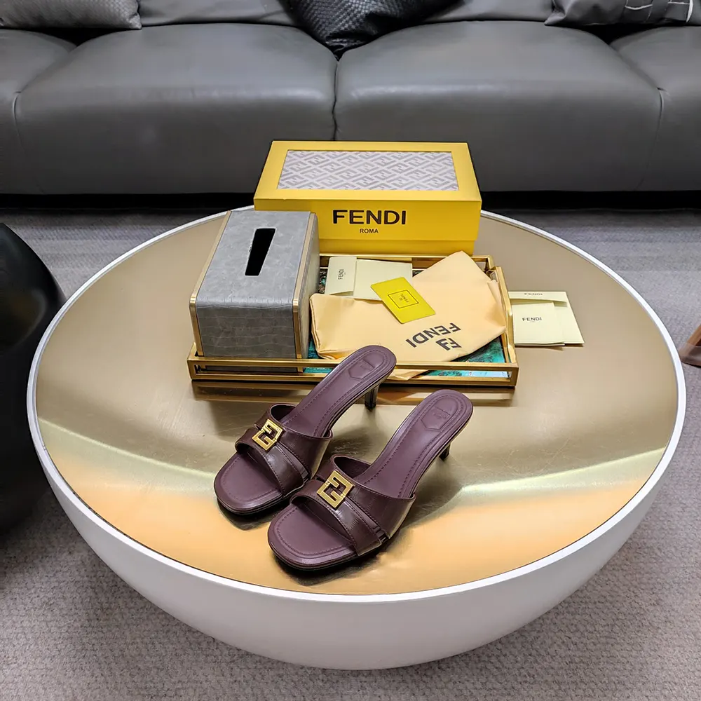 Close-up of Fendi FF logo hardware on black leather sandals