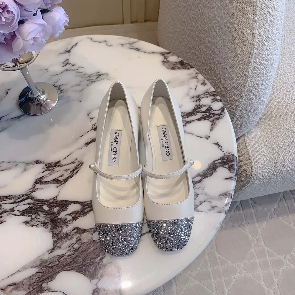Close-up of glitter leather and silver hardware on Jimmy Choo Elisa 45 pumps
