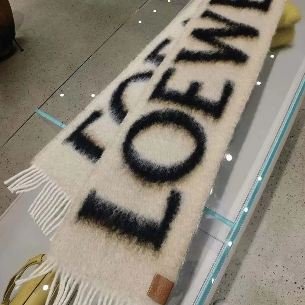 Close-up of embossed Loewe logo detail on scarf
