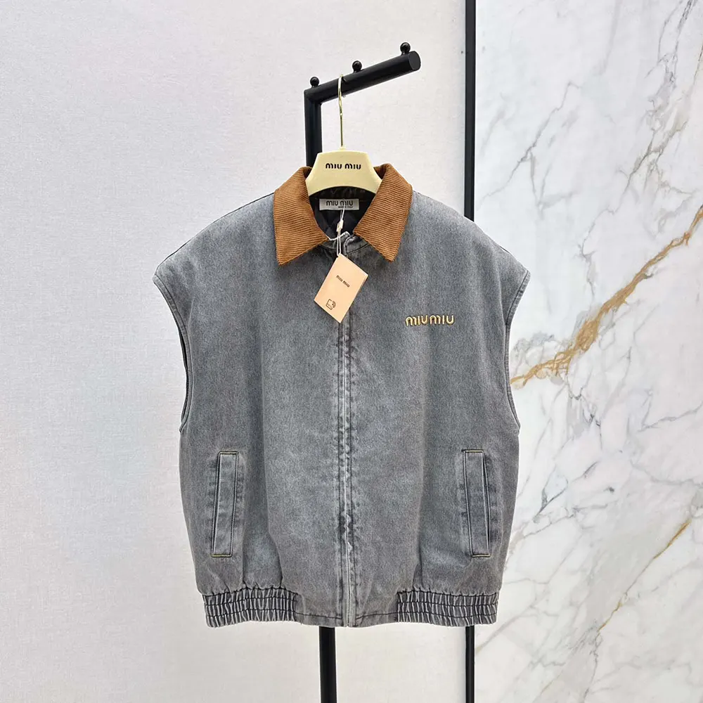 Close-up of gray chambray fabric and zipper on Miu Miu vest