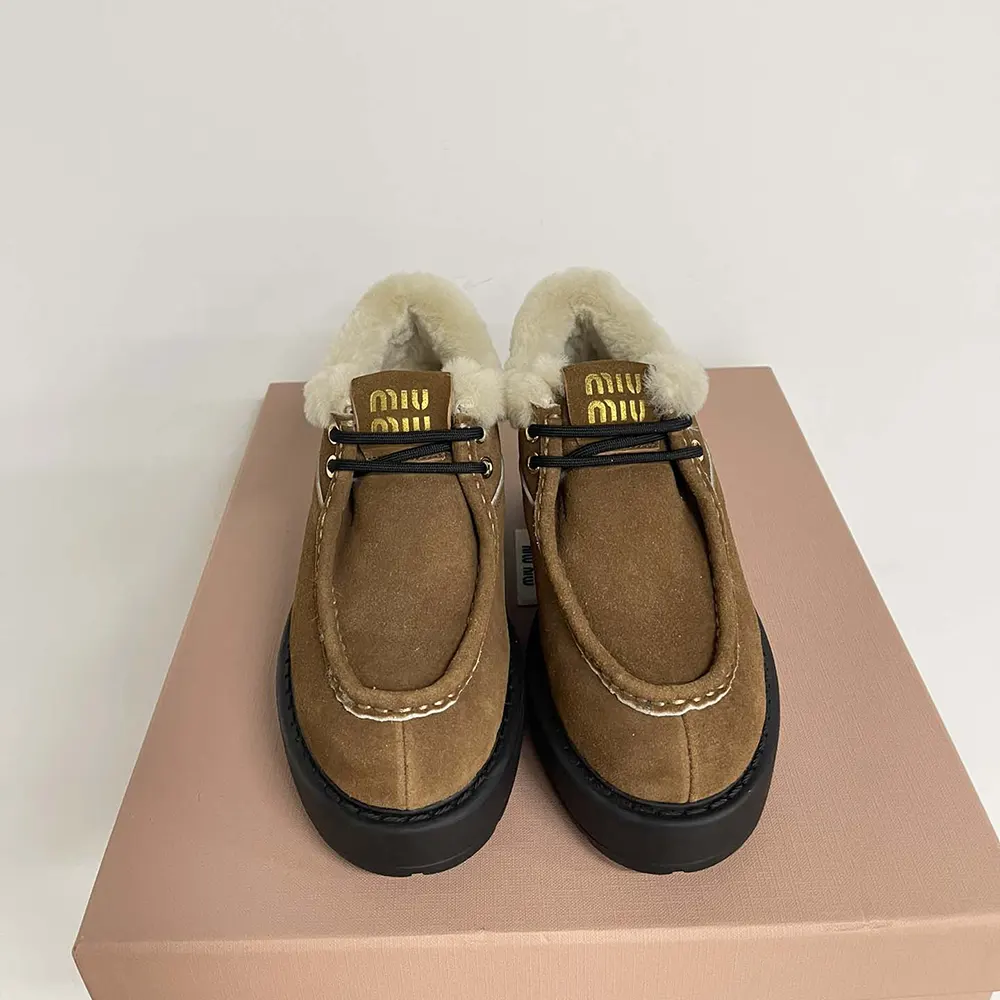 Close-up of zipper and silver hardware on Miu Miu booties