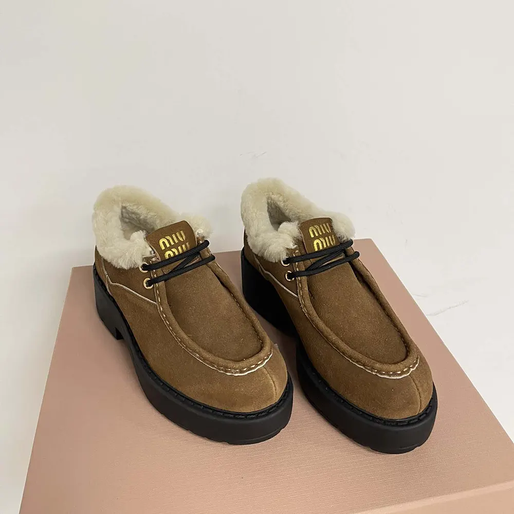 Top-down angle showing suede texture of Miu Miu booties