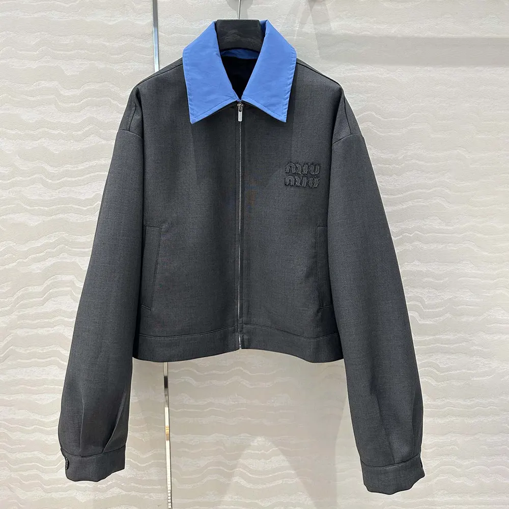 Close-up detail of poplin collar and silver-tone hardware on Miu Miu jacket