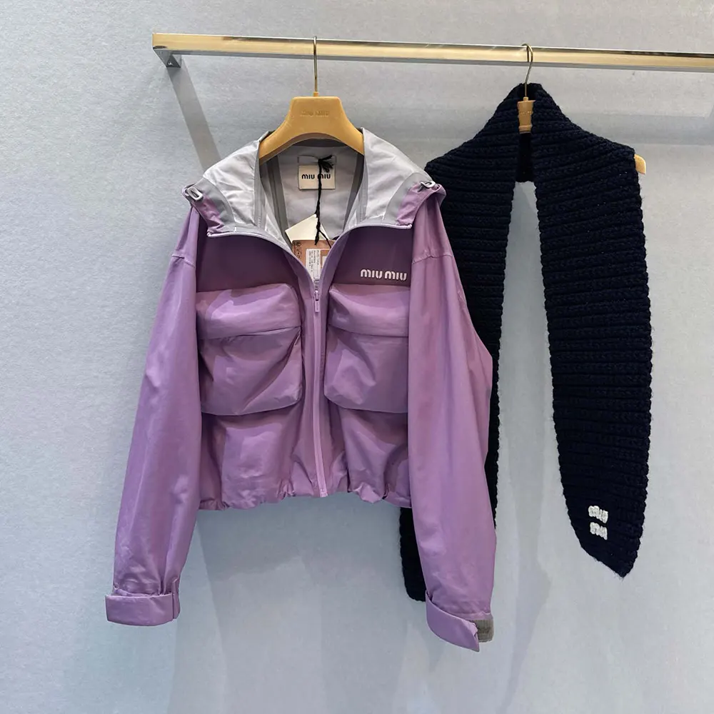 Close-up detail of zipped closure and hardware on Miu Miu blouson