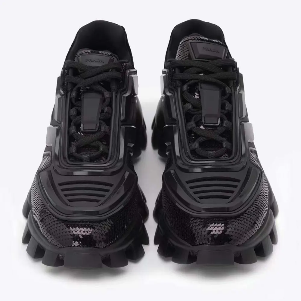 Close-up on black sequins and lug sole of Prada Cloudbust Thunder sneakers