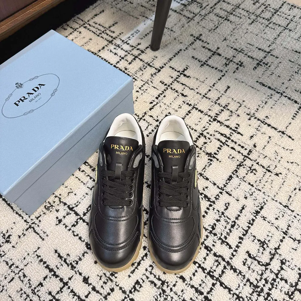 Close-up of black nappa leather and Prada logo on sneakers