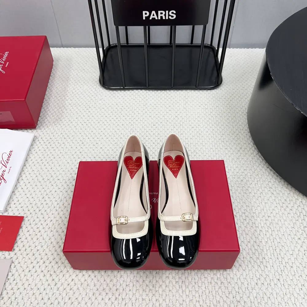 Close-up of signature square buckle on Roger Vivier black patent ballerinas
