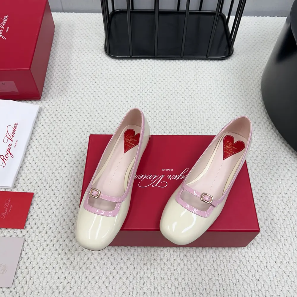 Top angle showing glossy white patent leather and silhouette of Viv’ Podium Ballerinas
