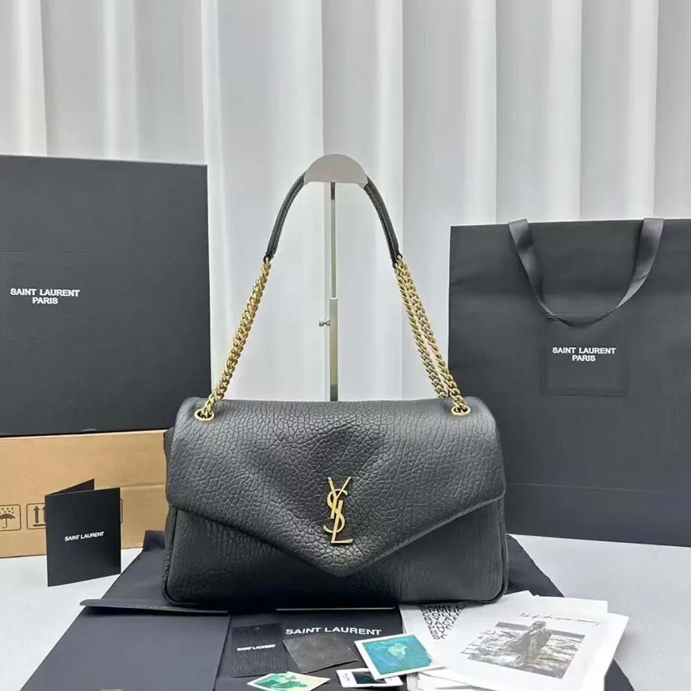 Close-up of gold YSL logo detail on Calypso Large shoulder bag