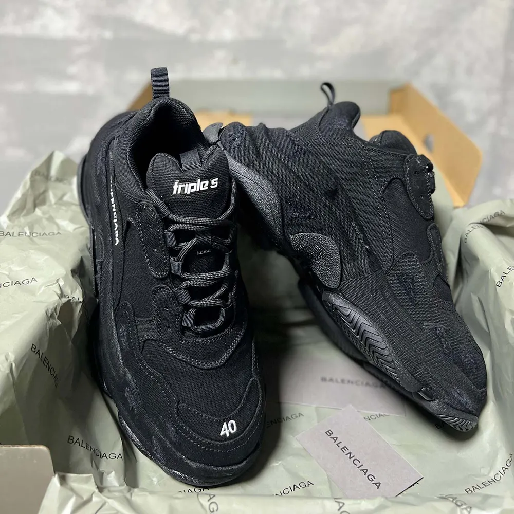 Close-up of black leather and mesh details on Balenciaga Triple S sneaker