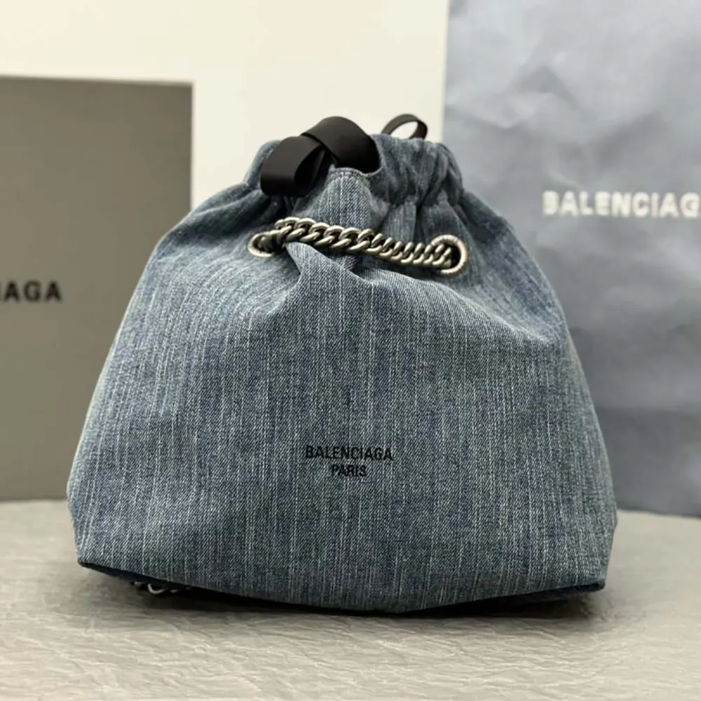 Close-up of crushed denim texture and silver hardware on Balenciaga tote