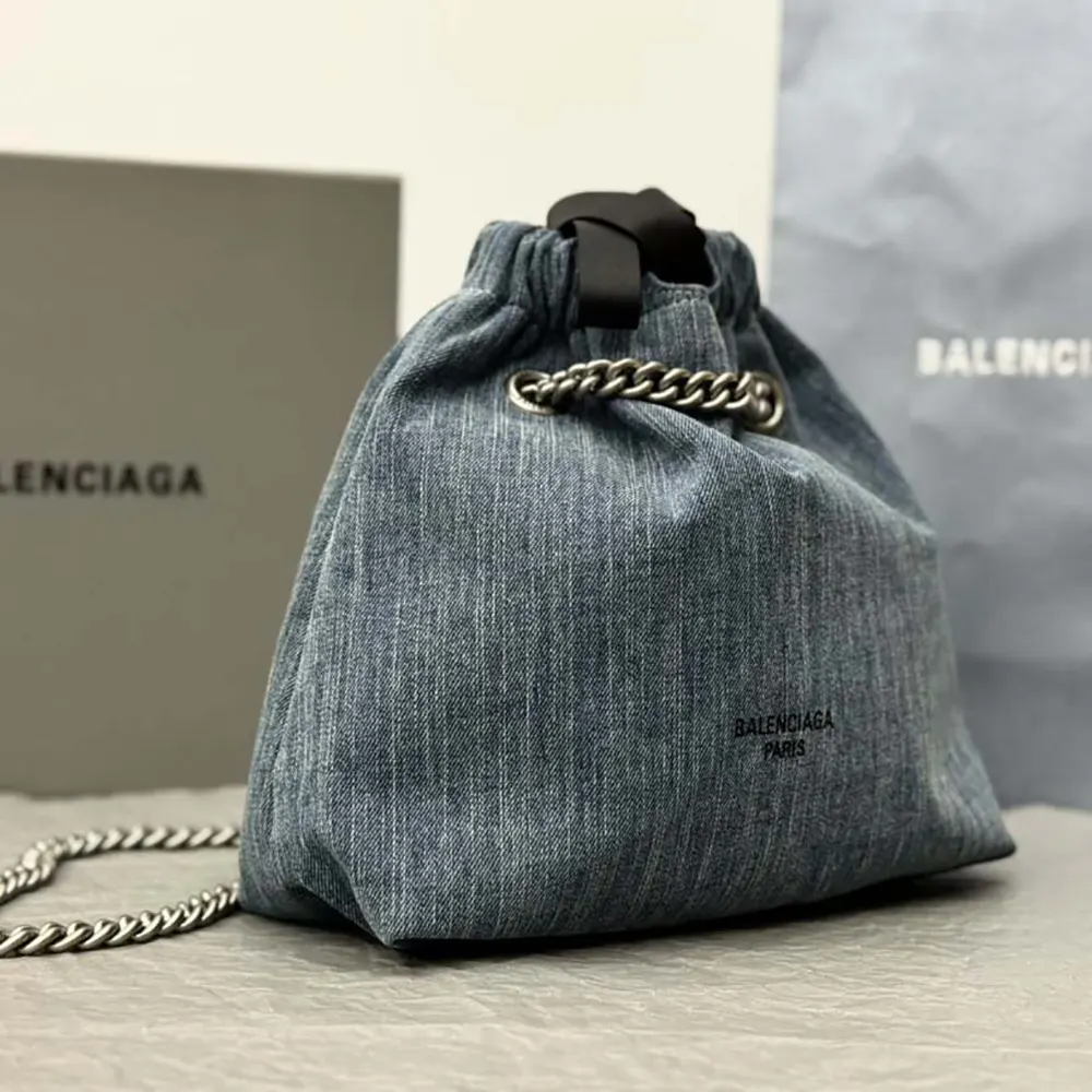 Side angle showing compact silhouette of Balenciaga Women Crush Small Tote Bag Denim