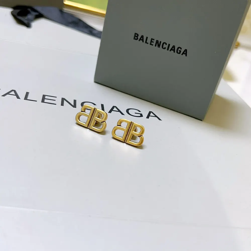 Close-up detail of the push-back closure on Balenciaga antique gold studs