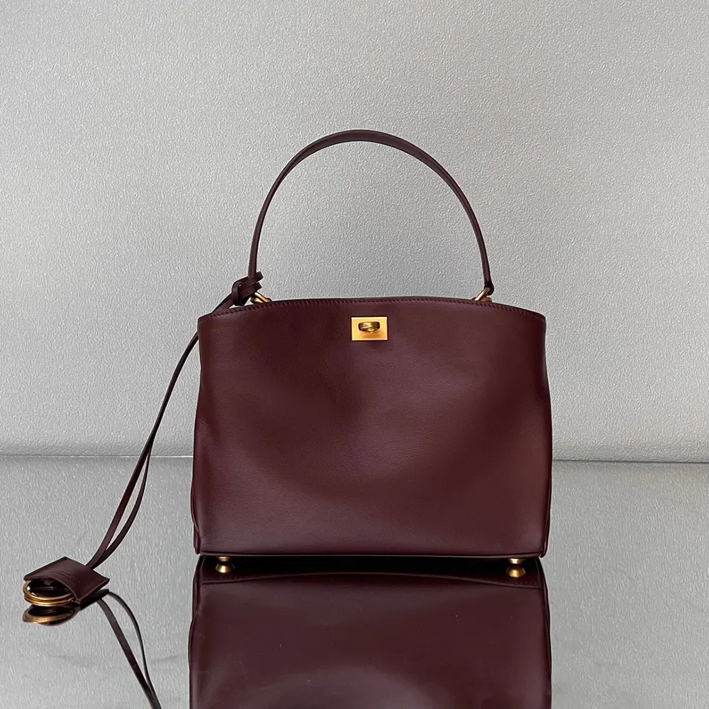 Side angle showing silhouette of Balenciaga Women Rodeo Mini Handbag burgundy