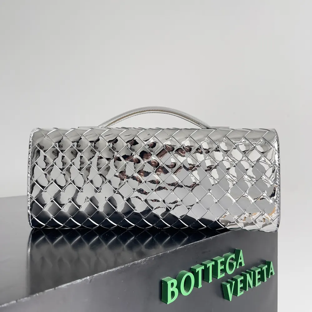 Side angle showing compact silhouette of Bottega Veneta Women Andiamo Clutch