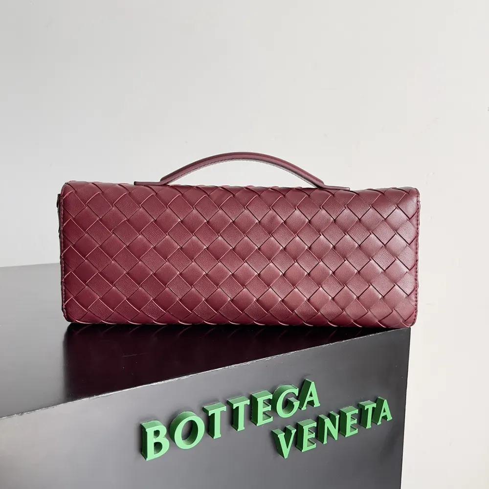 Side angle showing gold-tone hardware on Bottega Veneta Andiamo Clutch