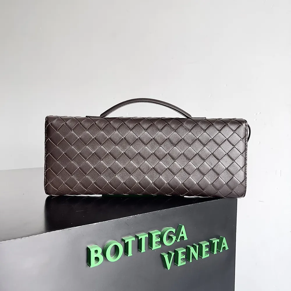 Side angle showing gold-tone hardware on Bottega Veneta Andiamo Clutch