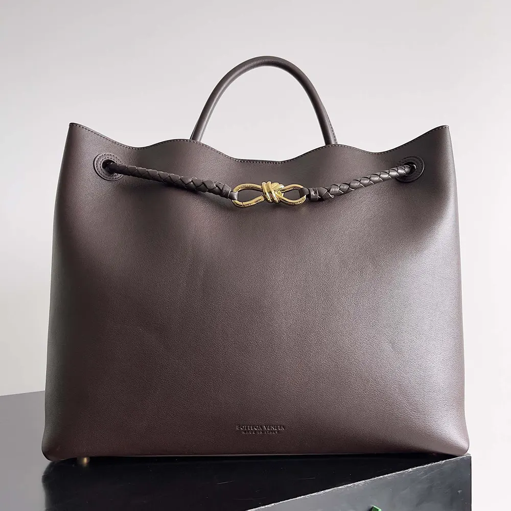 Close-up of burgundy silky calf leather and gold hardware on Andiamo bag