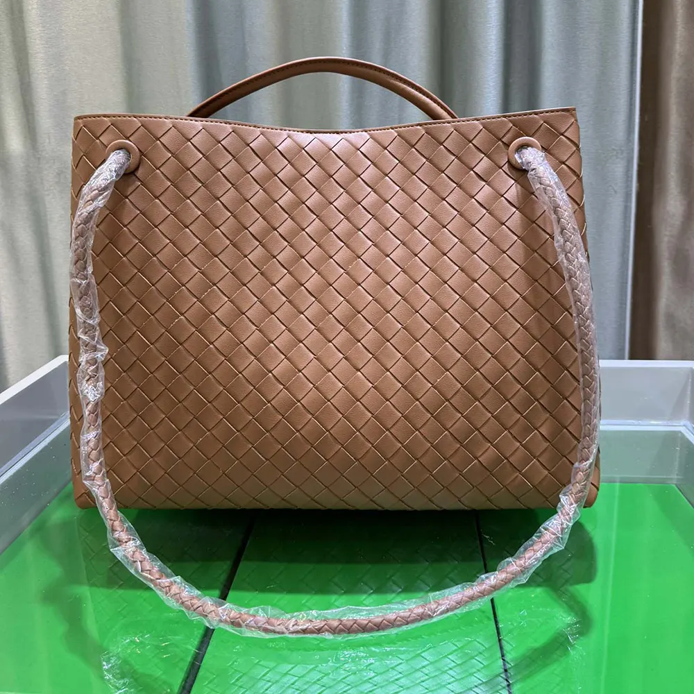 Detail of gold-tone hardware and magnetic snap on Bottega Veneta Medium Andiamo bag