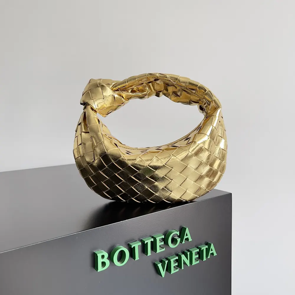 Close-up of intrecciato leather and knotted handle on Mini Jodie-Gold