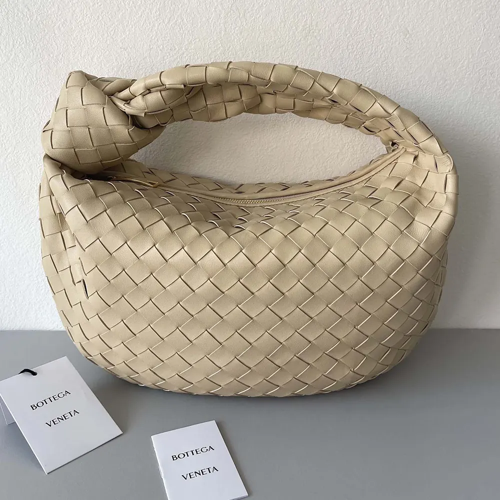Close-up of intrecciato woven leather detail on Small Jodie-Natural bag