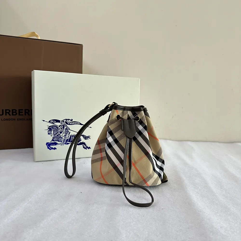 Close-up of drawstring closure and antique gold hardware on Burberry pouch