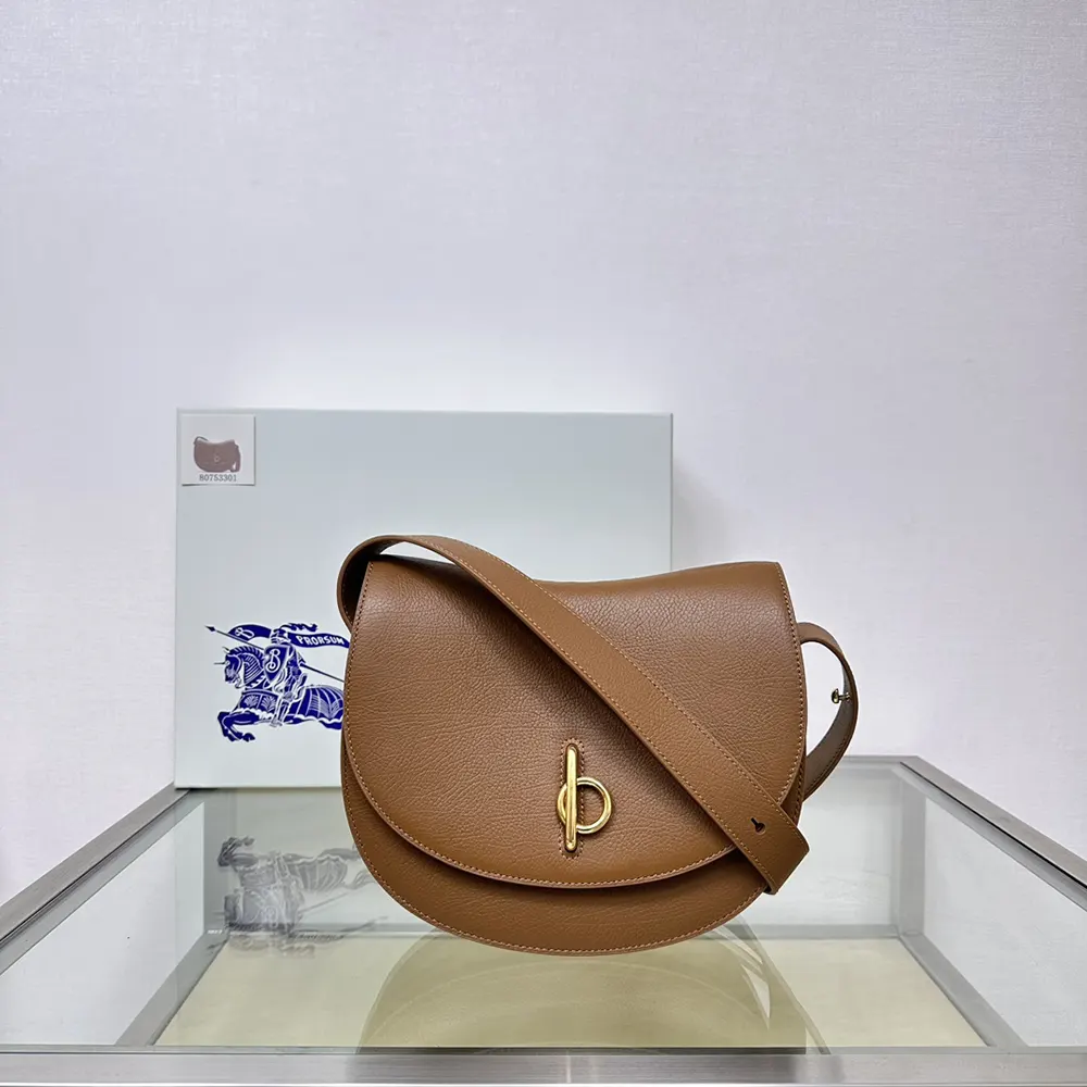 Close-up of gold-tone hardware on Burberry Women Medium Rocking Horse Bag