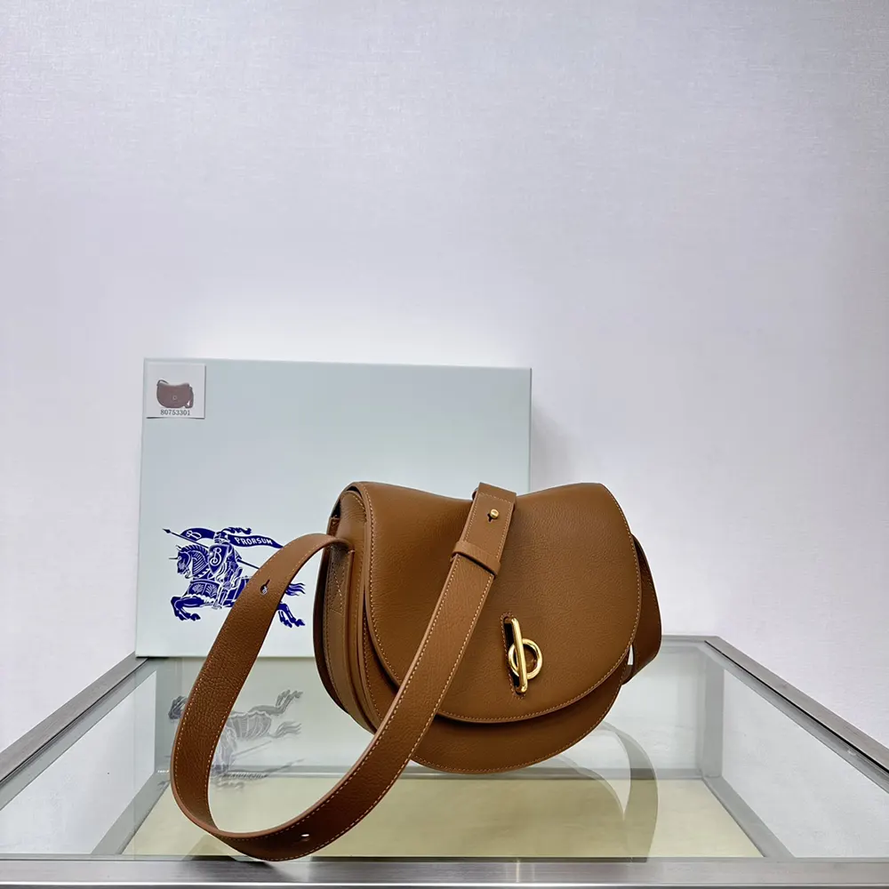 Side angle showing brown leather texture on Burberry Women Medium Rocking Horse Bag