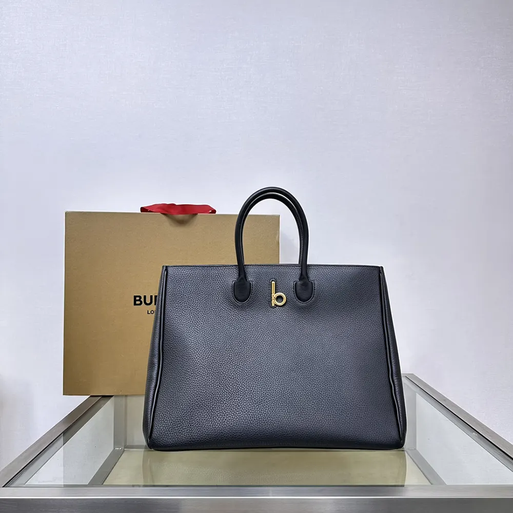 Close-up detail of black leather texture and signature Rocking Horse on tote
