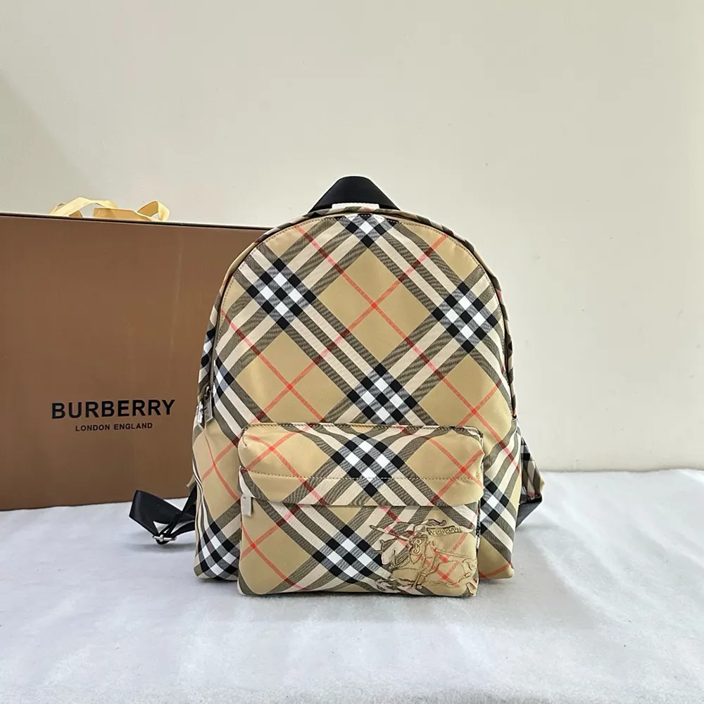 Close-up on gold-tone hardware and branded zip of the backpack
