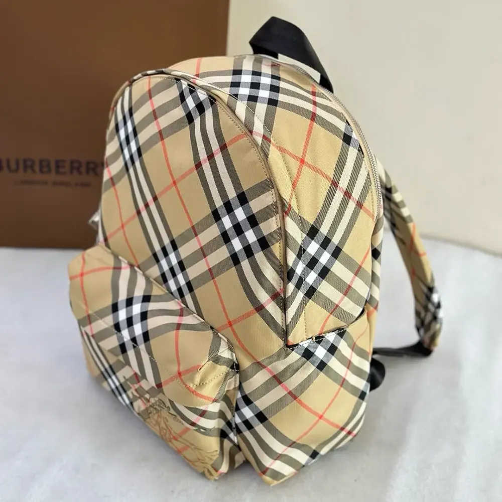 Side angle showing leather trim and adjustable straps of backpack