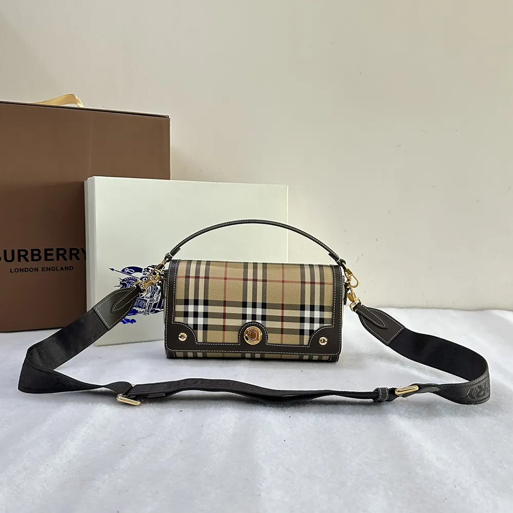 Close-up of gold-tone hardware on Burberry Women Top Handle Note Bag