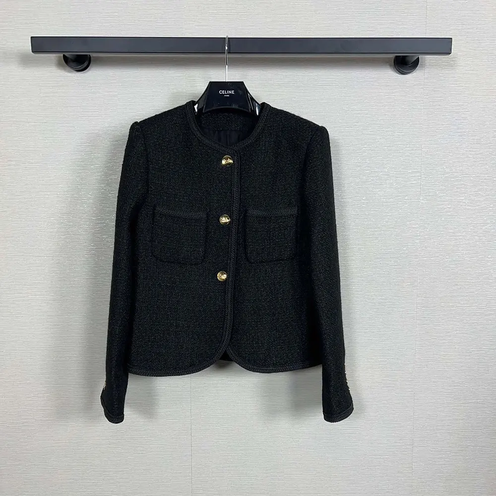 Close-up of gold-tone zipper and bouclé tweed texture on Celine jacket