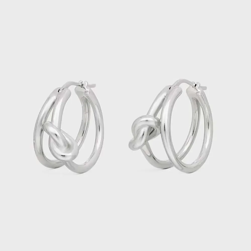 Front view of Celine Women Knot Double Hoops in silver brass