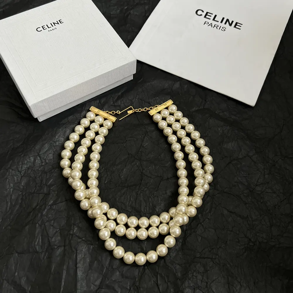 Side view of Celine Women Les Perles Celine Necklace gold-finished clasp