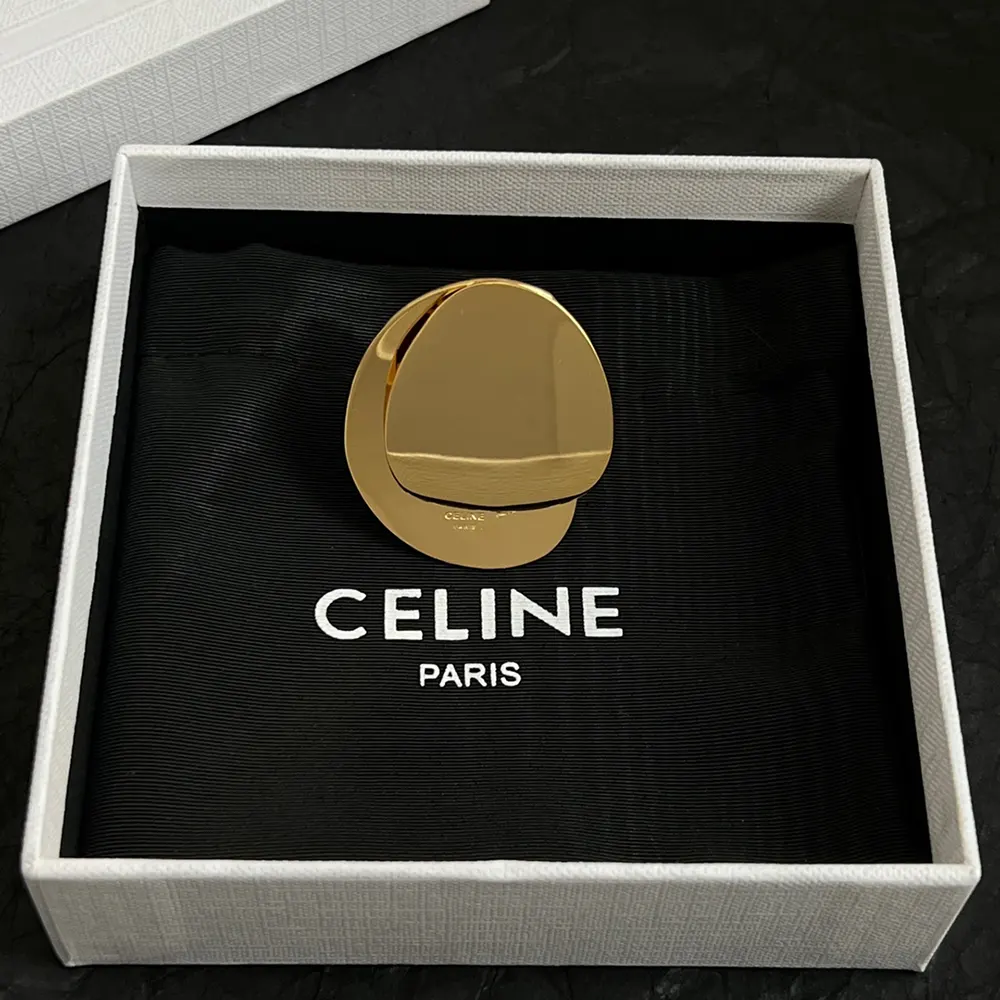 Worn shot of Celine Women Petale Ring in Brass with Gold Finish on female hand
