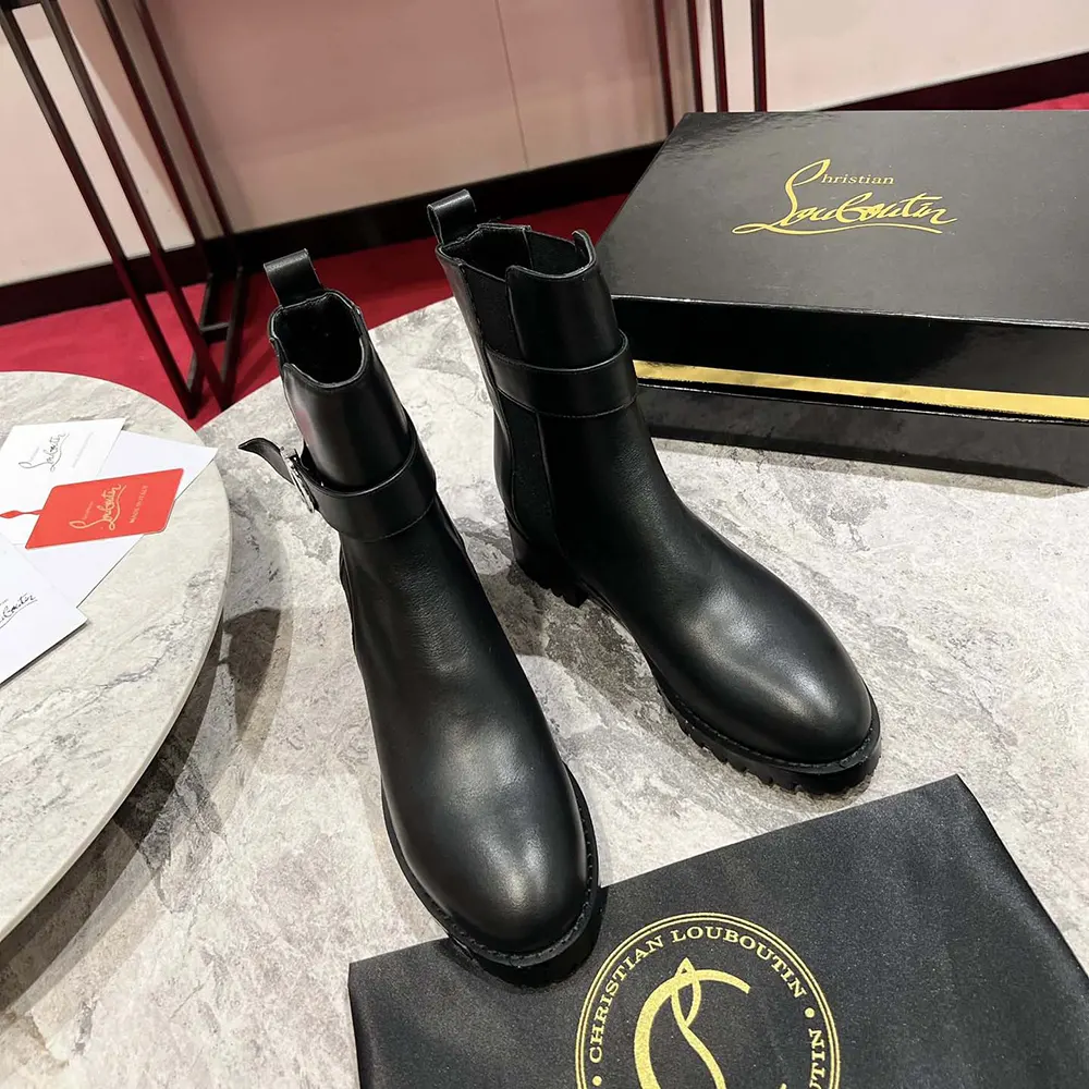 Close-up of red sole and elastic side panel on Christian Louboutin boots